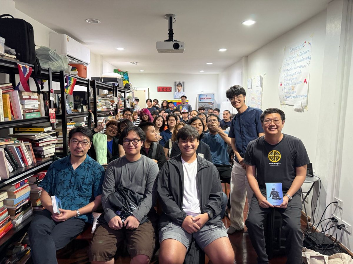 A packed, book-lined room at Delicious Democracy, the audience turned toward the camera after the debate.